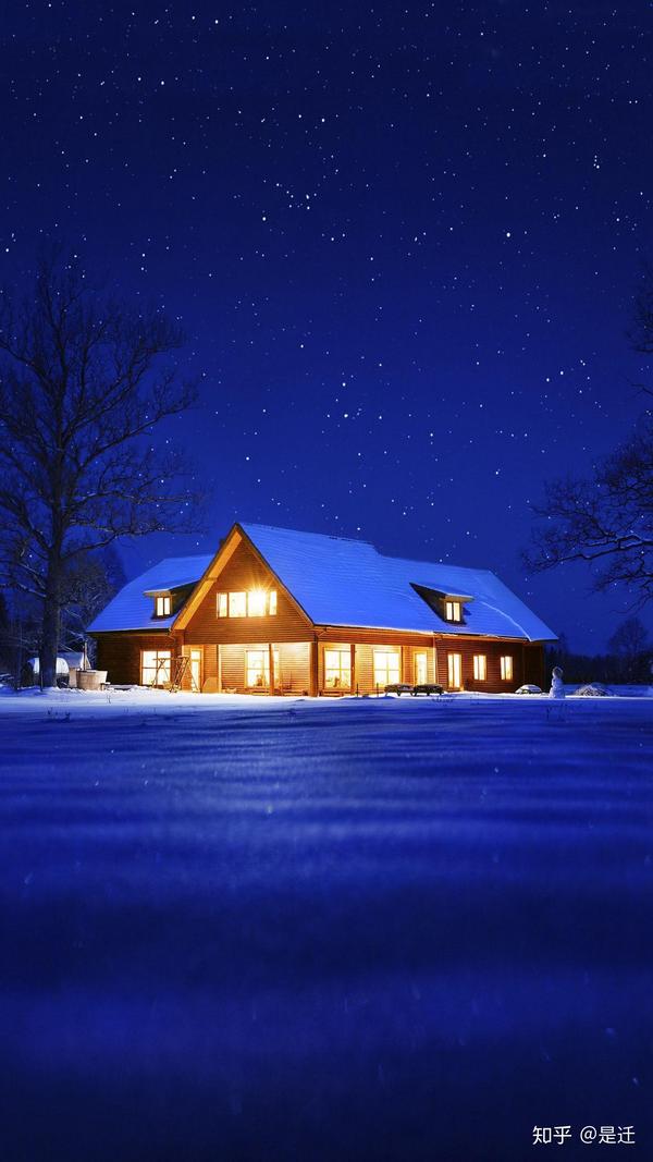 星空下静谧的雪地里,小屋的窗子透出柔和的灯光.