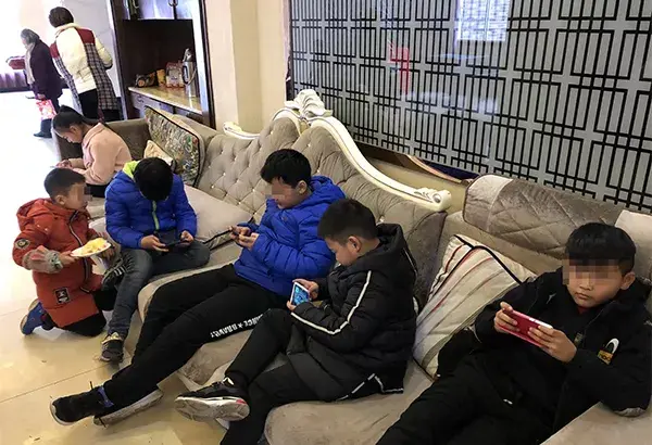 宴会上,小朋友人手一部手机,玩的不亦乐乎.