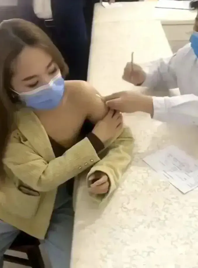 看似半露香肩实则有备而来;大家都知道,打疫苗时需要撸起袖子管露出